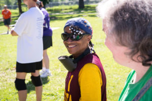 woman smiling during beep baseball game