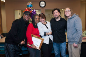 four students, one instructor standing and smiling at party in Rehabilitation center