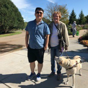 Client with volunteer and guide dog