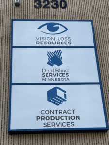 Building number 3230 with three stacked logos for Vision Loss Resources, DefBlind Services Minnesota, and COntract Produciotn Services