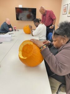 Student carving a pumpkin