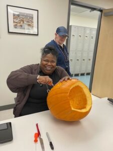 Student carving a pumpkin