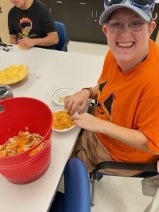 Student smiling separating the pumpkin seeds from the gunk
