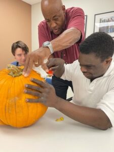 John getting help from Instructor Kelly carving the pumpkin